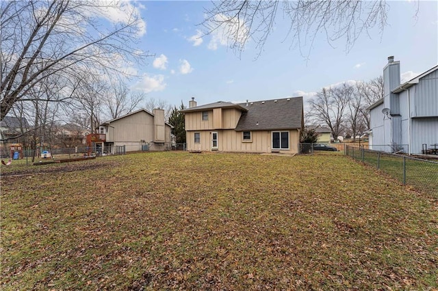 rear view of house with a lawn