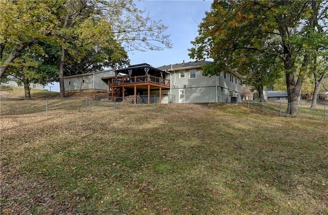 back of property featuring a yard and a deck