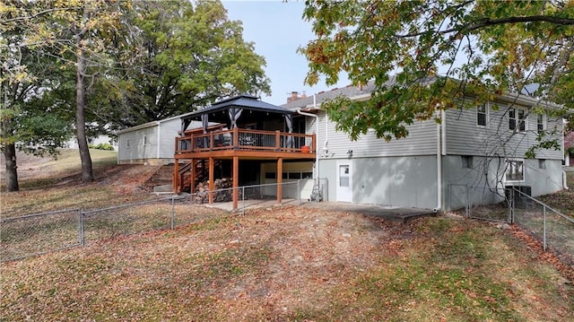 back of house featuring a wooden deck