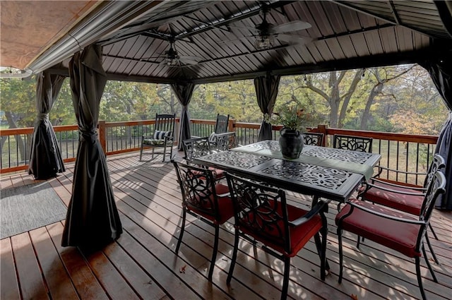 wooden terrace featuring a gazebo and ceiling fan