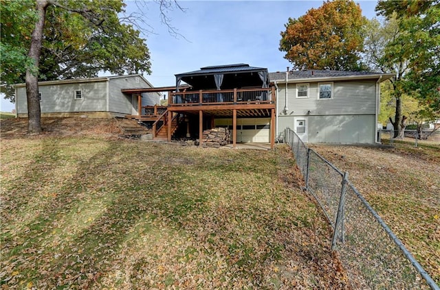 back of house with a wooden deck and a yard