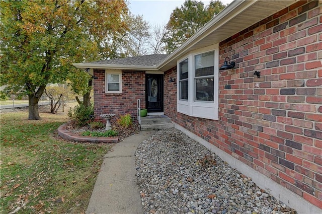 entrance to property with a lawn