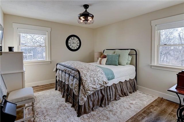 bedroom featuring multiple windows and hardwood / wood-style flooring