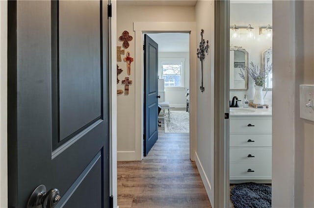 hallway featuring sink and dark hardwood / wood-style flooring