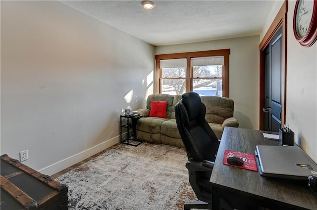 office area with wood-type flooring and a textured ceiling