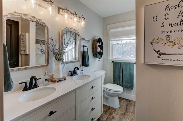 bathroom with vanity, hardwood / wood-style floors, and toilet