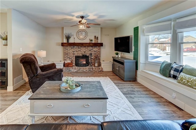 living room with ceiling fan and light wood-type flooring