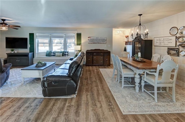 dining room with ceiling fan with notable chandelier and hardwood / wood-style floors