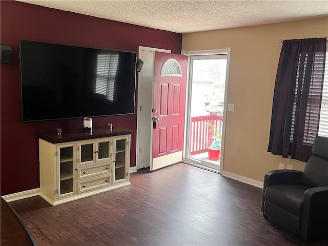 foyer entrance with hardwood / wood-style floors and a textured ceiling