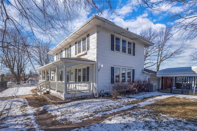 view of snowy exterior with a porch