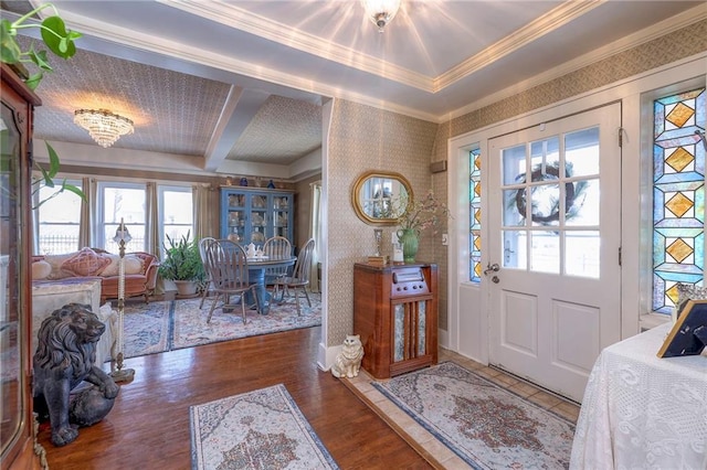 foyer with ornamental molding and dark wood-type flooring