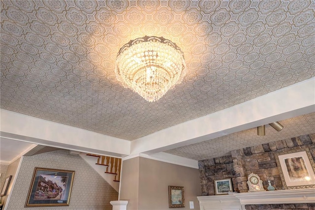 interior details with a textured ceiling, a notable chandelier, and beam ceiling