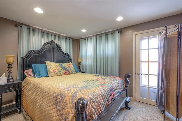 carpeted bedroom featuring multiple windows