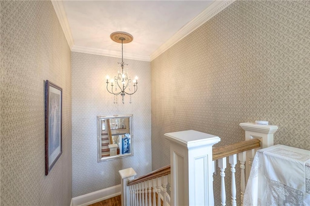 corridor with crown molding and a notable chandelier