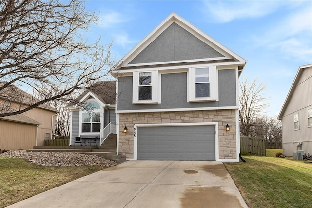 view of front of home featuring a garage, cooling unit, and a front lawn