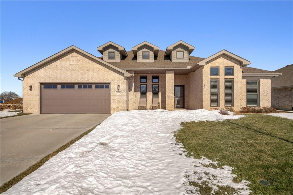 view of front of house with a garage and a yard