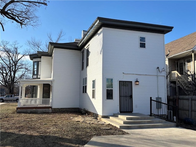 back of property with a porch