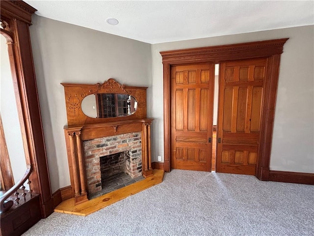 living room featuring a brick fireplace and light colored carpet