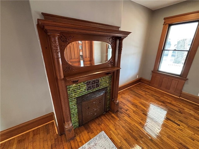 interior space with hardwood / wood-style flooring and a tile fireplace