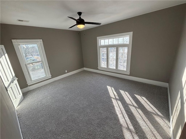 empty room with ceiling fan and carpet flooring