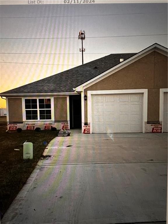 ranch-style house featuring a garage