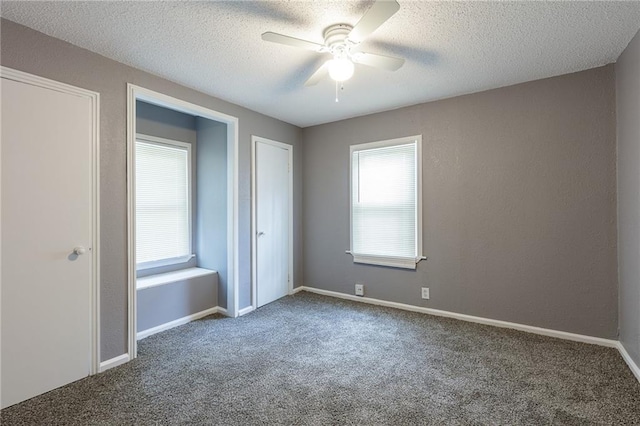 unfurnished bedroom featuring a textured ceiling, ceiling fan, and carpet floors