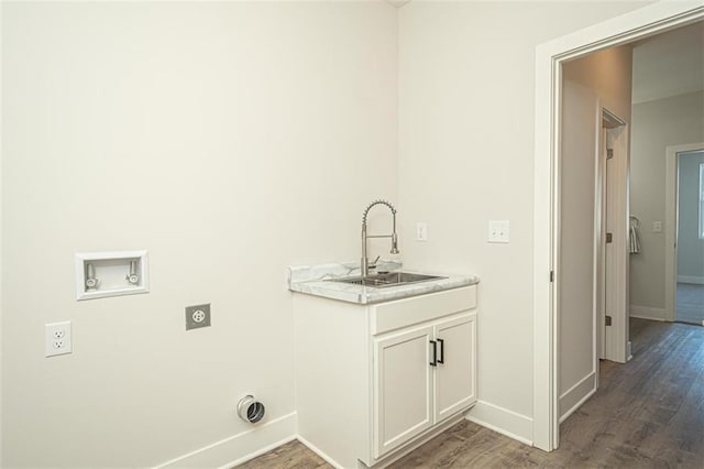 laundry room featuring cabinets, dark hardwood / wood-style flooring, electric dryer hookup, sink, and washer hookup