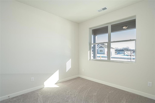 unfurnished room featuring carpet