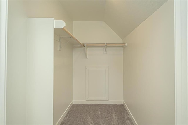 walk in closet with carpet flooring and vaulted ceiling