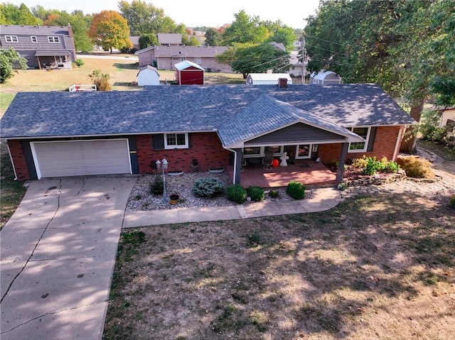 ranch-style home featuring covered porch and a garage