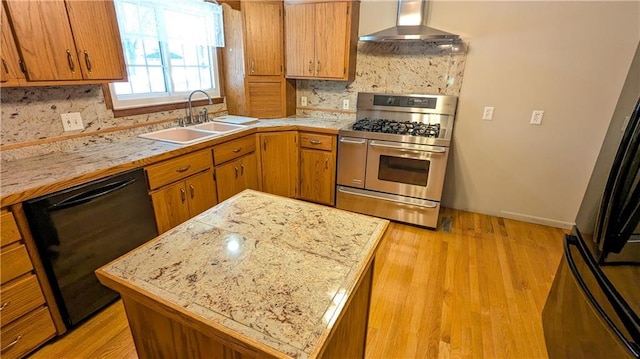 kitchen with wall chimney range hood, backsplash, black appliances, and sink