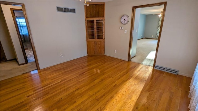 spare room featuring ceiling fan and light wood-type flooring