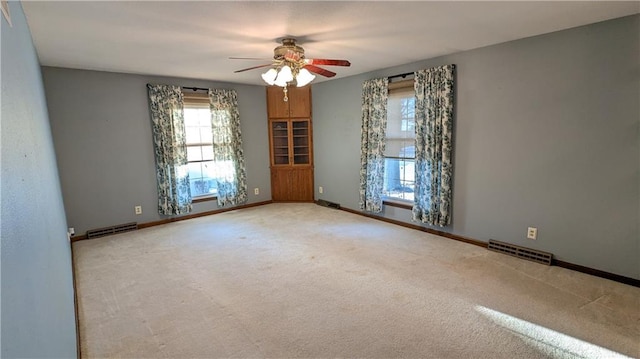 carpeted empty room with ceiling fan