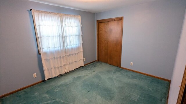 unfurnished bedroom featuring a closet and carpet flooring