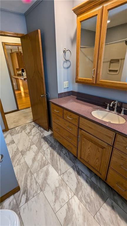 bathroom featuring crown molding and vanity