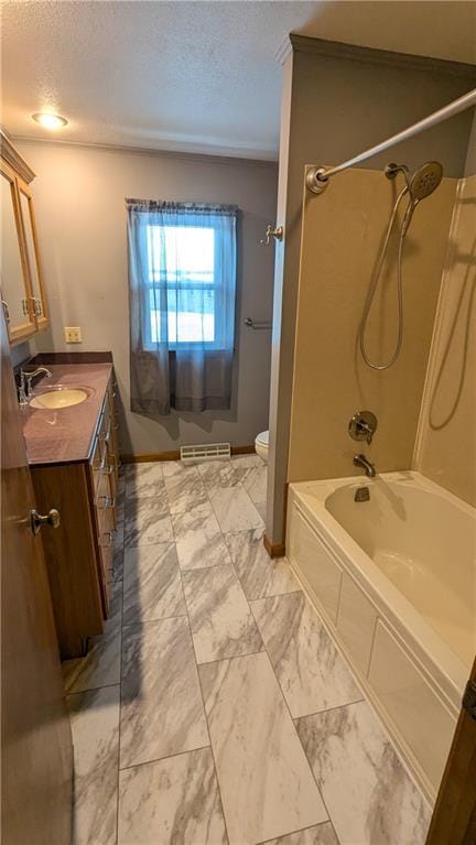 full bathroom featuring shower / bath combination, toilet, a textured ceiling, and vanity