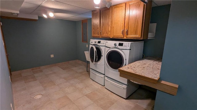 washroom with cabinets and washing machine and clothes dryer