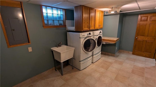 laundry area with electric panel, cabinets, and separate washer and dryer