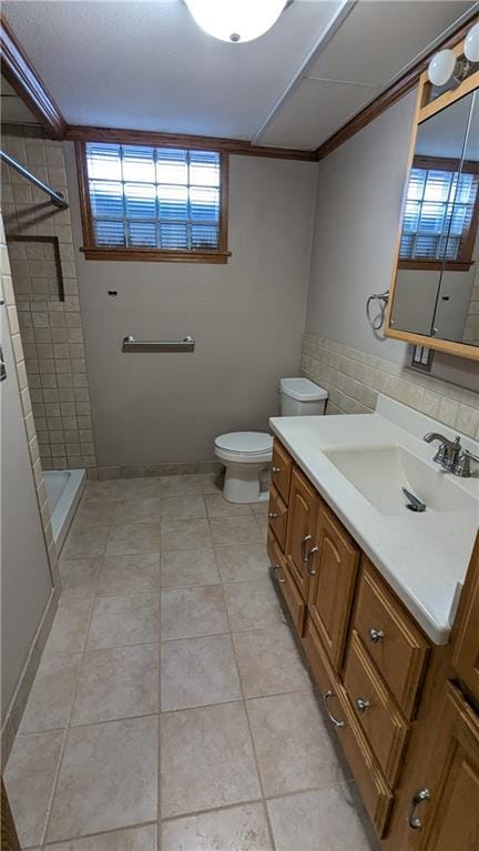 bathroom with toilet, tile patterned flooring, walk in shower, and vanity