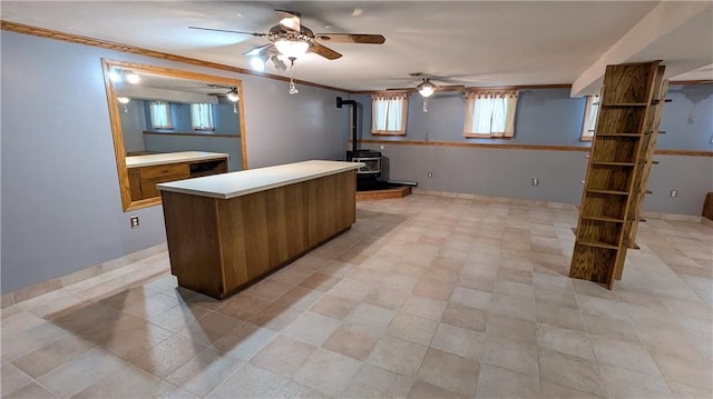 kitchen with a wood stove and crown molding