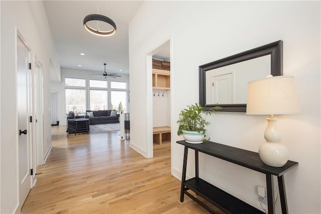 corridor with light hardwood / wood-style floors