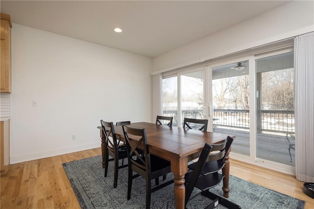 dining room featuring light wood-type flooring, baseboards, and recessed lighting