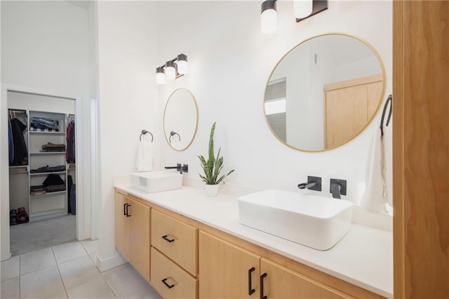 bathroom featuring tile patterned flooring and vanity