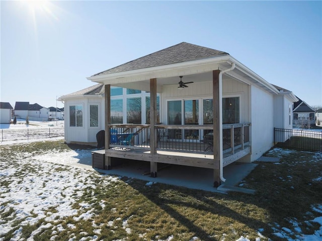 rear view of property featuring a deck, roof with shingles, fence, and a ceiling fan