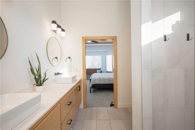 bathroom featuring a shower with door, vanity, and tile patterned flooring