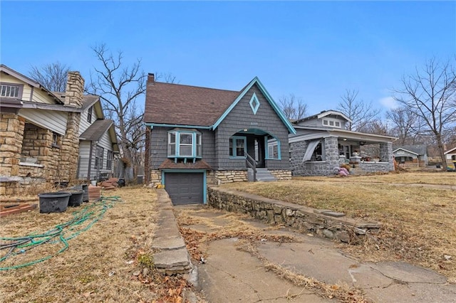 view of front of home with a garage and a front lawn