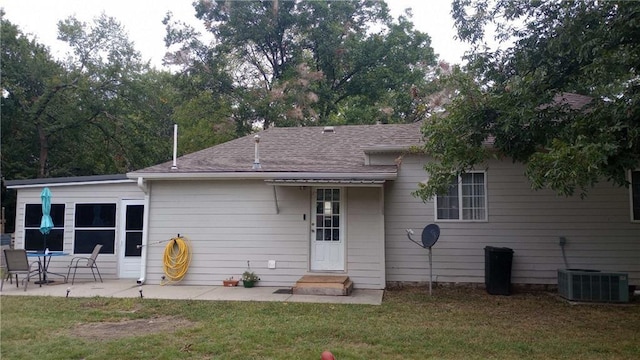 view of front of home with a patio area, cooling unit, and a front lawn