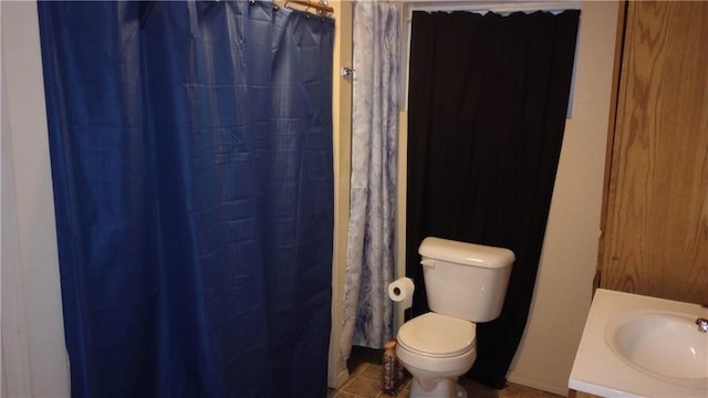 bathroom featuring toilet, vanity, and walk in shower