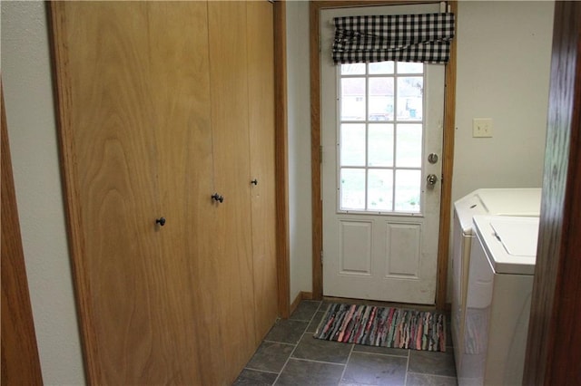 laundry area with stone finish floor, laundry area, washing machine and dryer, and a wealth of natural light
