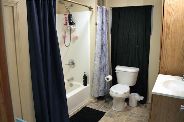 bathroom with vanity, toilet, and shower / tub combo